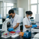 Indian lab technicians working in a modern BMLT course laboratory, using a microscope and a blood analyzer.